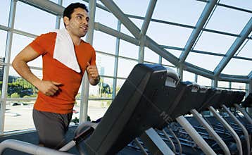 Man Exercising On Treadmill In Gym