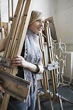 Art Student Carrying Easel In Studio