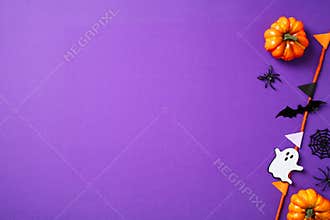 Halloween party decorations, pumpkins, spiders, ghosts, bunting garland on purple background. Happy Halloween concept