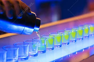 Shots on a bar with warm lightning and blue colors