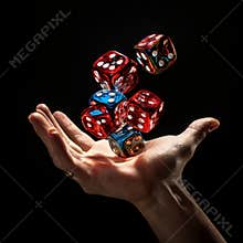 Hand juggling colorful dice in mid-air against a dark background