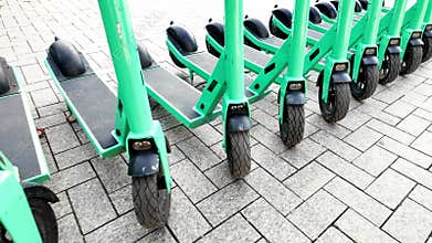 Row of electric scooters for public share.