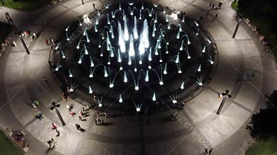 Tilt up aerial on fountain in night Kharkiv city