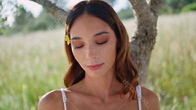 Thoughtful woman holding book at meadow portrait. Lady author looking distance