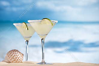 Margarita cocktail on beach, blue sea and sky