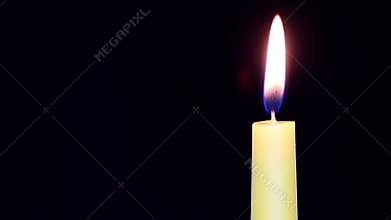 Burning candle in a dark