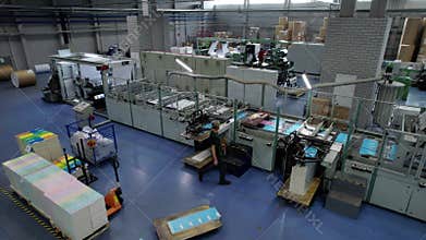 Worker manages material processing in cardboard factory FPV