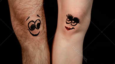 Male and female legs with funny faces falling in love