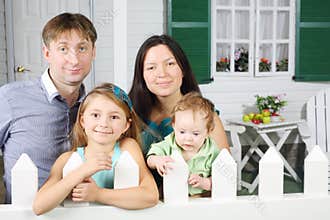 Happy father, mother, baby and little daughter stand