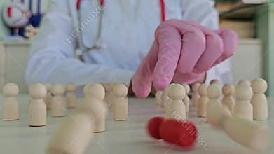Doctor explains patient health status using wooden figures
