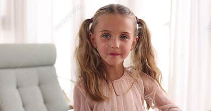 Close up of a 5-year-old girl looking at camera, creating a powerful