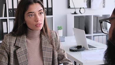 Caucasian Female Broker Consulting Client In Office