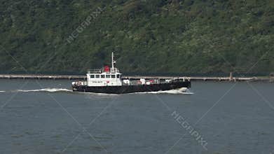 A pilot boat returning to harbor after dropping off the pilot on a ship