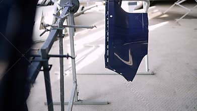 Car body part after painting. Drying car parts in a paint booth. Car bumper drying after painting.