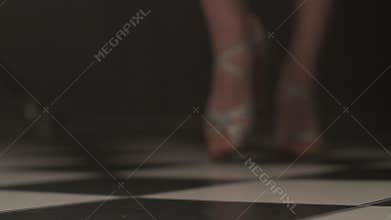 sexy dance practice in the hall on the floor. salsa and ballroom dancing. female legs in high-heeled shoes, viewed from