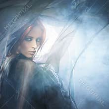 A young redhead woman in blue and red silk clothes