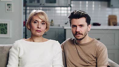 An adult son and mature mother. Healthy and happy relations between two generations. Parent and grown up child. Mid shot