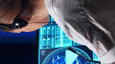 Workplace of the air traffic controllers in the control tower. Team of professional aircraft control officers works