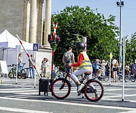 A Hungarian girl under the age of ten rides a bicycle on Bike Day on May 11 in Budapest's H?sök square.