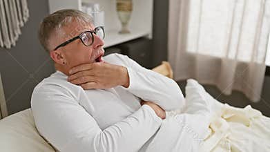 Middle-aged grey-haired man in pyjamas left wide-eyed, jaw almost at bed, in sheer disbelief and amazement at a shocking