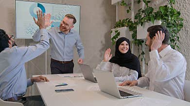 Happy team colleagues celebrate winning business deal achieve victory give high five multiethnic businessmen and muslim