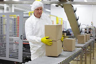 Worker working on packing line in factory