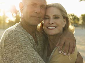 Happy Senior Couple Embracing On Beach