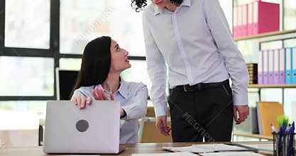 Interested curious corporate spy looking at colleague laptop