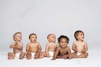 Babies Sitting Side By Side Looking Away