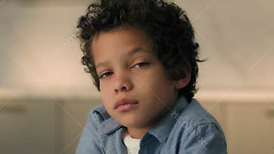 Close up portrait little sad pensive kid African American ethnic boy son cute offended punished child alone male baby