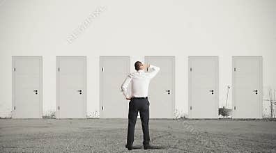 Businessman choosing the right door