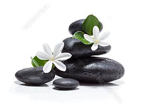 Massage tiare flowers, candle and black stone spa