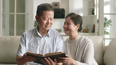 senior asian couple reading bible together
