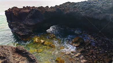 Picturesque rock formations by the sea, beaten by the waves that form caves, La Palma, Canary Islands.