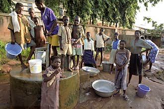 Young people fetch water at a water pump