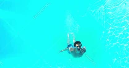 Happy man diving into swimming pool