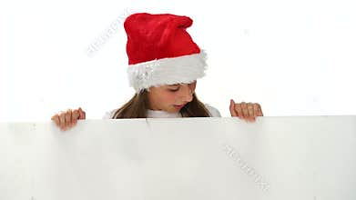 Young girl in a Christmas hat with a blank sign