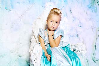 Little girl in princess dress on a background of a winter fairy