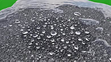 Realistic Puddle Evaporation Simulation Close Up on Textured Surface with Green Screen Background