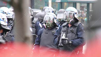 Heavily armed riot police officers with gas masks and horses