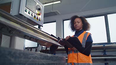 African American female worker using digital tablet in a metal processing factory