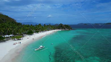 bangka boat at Malcapuya Island beach, turquoise sea. Best aerial view drone