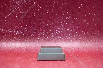 Stand with clear base on a shiny pink background with sparkles and blurred details in the picture