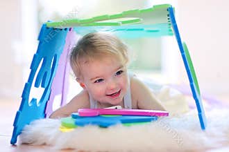 Little girl playing with puzzles