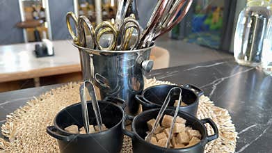 Brown sugar squares, scissors in a cafe for people, serving with tea, pizza, various utensils