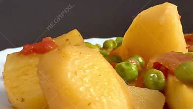 Pork chop with peas and potatoes.