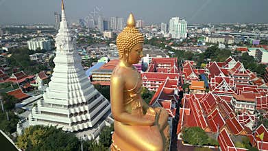 Aerial view of golden Buddha and white stupa in Bangkok, Thailand