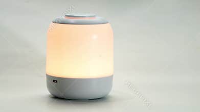 Rechargeable touch control bedside multi functional night light on white background.