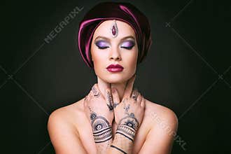Beautiful woman in oriental style with mehendi