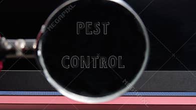 PEST CONTROL words appear through a magnifying glass on a black monitor. Health and productivity concept